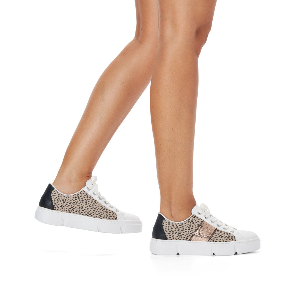 Rieker N5910-90 Ladies Trainers Fabulous white, flat lace-up trainers with fashionable print and rose-gold side detail from Rieker. Colour: White / Multi Round toe shape Lace-up closure Soft textile lining Comfortable leather footbed Upper: Synthetic Lining & Sock: Leather/Textile Outer Sole: Other Material Colours Ltd, Colours, Colours Farnham, Colours Shoes